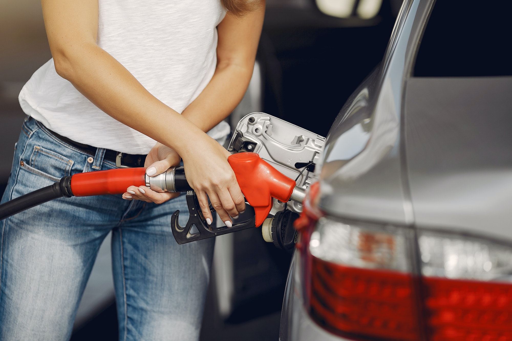 Elegant woman standing on a gas station