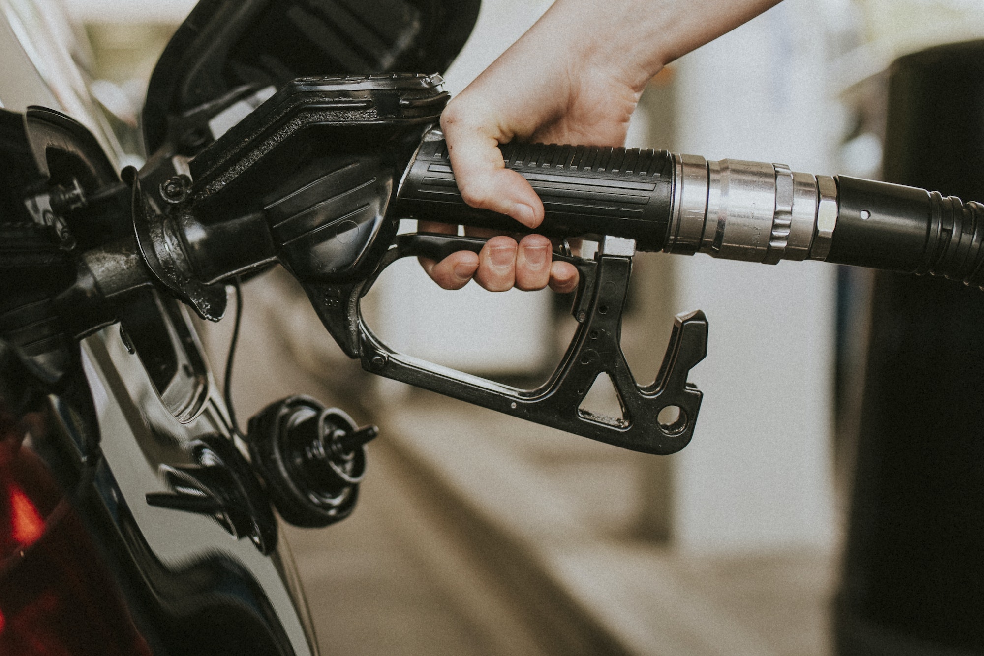 Woman filling petrol at a gas station